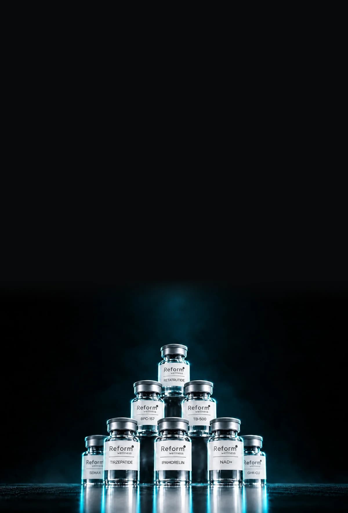 A pyramid formation of Reform Wellness peptide vials under studio lighting